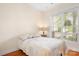 This bright bedroom features a cozy bed and plenty of natural light from the large window at 14541 Holly Springs Dr, Huntersville, NC 28078