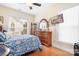 This bedroom offers a comfortable bed and a large dresser with decorative mirror and a TV at 14541 Holly Springs Dr, Huntersville, NC 28078