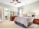 This spacious bedroom features light green walls, a double bed and a dresser at 14541 Holly Springs Dr, Huntersville, NC 28078
