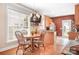 Charming breakfast nook with a wooden table, chairs, natural light, and access to the kitchen at 14541 Holly Springs Dr, Huntersville, NC 28078