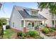 Delightful home featuring a quaint front porch, lush landscaping, and attractive exterior design at 14541 Holly Springs Dr, Huntersville, NC 28078