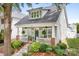 Beautiful home showcasing a lovely front porch with seating, manicured landscaping, and inviting curb appeal at 14541 Holly Springs Dr, Huntersville, NC 28078