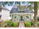 Charming home featuring a welcoming front porch, landscaped yard, and classic architectural details at 14541 Holly Springs Dr, Huntersville, NC 28078