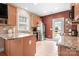 Bright kitchen with granite countertops, stainless steel appliances, and a view to the backyard at 14541 Holly Springs Dr, Huntersville, NC 28078