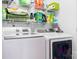 This laundry room features a washer, dryer and wire shelving above for ample storage at 14541 Holly Springs Dr, Huntersville, NC 28078