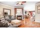 Cozy living room with a fireplace, hardwood floors, comfortable seating, and open-concept design at 14541 Holly Springs Dr, Huntersville, NC 28078