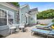 An outdoor patio featuring chairs, lounge seating, and a dining table under an umbrella at 14541 Holly Springs Dr, Huntersville, NC 28078