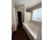 Bathroom featuring a jacuzzi tub and a window providing natural light at 1507 Rumstone Ln, Charlotte, NC 28262