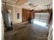 Spacious garage featuring an open garage door, water heater, and concrete flooring at 1507 Rumstone Ln, Charlotte, NC 28262
