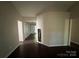 Hallway with dark floors leading to several rooms, offering an open and inviting space at 1507 Rumstone Ln, Charlotte, NC 28262
