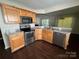 Well-lit kitchen with stainless steel appliances, wood cabinets, and granite countertops at 1507 Rumstone Ln, Charlotte, NC 28262