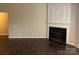 Spacious living room with dark hardwood floors and a fireplace at 1507 Rumstone Ln, Charlotte, NC 28262