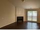 Bright living room featuring a fireplace and dark hardwood floors at 1507 Rumstone Ln, Charlotte, NC 28262