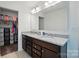 Bright bathroom featuring double granite vanity, large mirror, and entry to walk-in closet at 1578 Whitman Ct, York, SC 29745