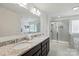 Bright bathroom featuring double granite vanity, large mirror, walk-in shower, and soaking tub at 1578 Whitman Ct, York, SC 29745