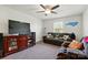 Bedroom featuring a ceiling fan, large TV, and comfortable seating at 1578 Whitman Ct, York, SC 29745