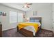 Bedroom featuring a ceiling fan, large windows, and a bed with a yellow throw blanket at 1578 Whitman Ct, York, SC 29745