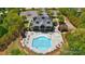 Aerial view of a community pool and clubhouse with a deck and plenty of seating at 1578 Whitman Ct, York, SC 29745