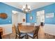 Bright dining room features wood table and blue walls with white trim; perfect for Gathering meals and entertaining at 1578 Whitman Ct, York, SC 29745