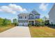 Attractive two-story home with a two-car garage, a welcoming front porch, and a well-kept lawn at 1578 Whitman Ct, York, SC 29745