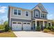 Attractive two-story home featuring a two-car garage, inviting front porch and professionally landscaped lawn at 1578 Whitman Ct, York, SC 29745