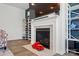 Stylish fireplace with white mantel, a large television, shelving, and wood flooring at 1578 Whitman Ct, York, SC 29745