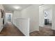 Upstairs hallway with neutral carpet and white walls, leading to bedrooms; functional and well-lit at 1578 Whitman Ct, York, SC 29745