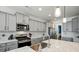 Bright kitchen with stainless steel appliances, modern cabinetry, and a marble countertop island at 1578 Whitman Ct, York, SC 29745