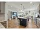 Open-concept kitchen with central island with seating flows seamlessly into the living room at 1578 Whitman Ct, York, SC 29745