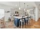 Well-lit kitchen with a central island with barstool seating, white cabinets, and modern stainless steel appliances at 1578 Whitman Ct, York, SC 29745