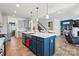 Kitchen island with bar seating, stainless steel appliances, and view of the living area at 1578 Whitman Ct, York, SC 29745