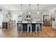 Open-concept kitchen with an island, three stools, and modern appliances at 1578 Whitman Ct, York, SC 29745