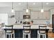 Spacious kitchen features white countertops, modern appliances, and an island with barstool seating and pendant lights at 1578 Whitman Ct, York, SC 29745