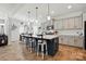 Bright kitchen boasts a center island with barstool seating, pendant lighting, and stainless steel appliances at 1578 Whitman Ct, York, SC 29745