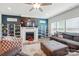Bright living room with a fireplace, a large television, shelving, and comfortable seating at 1578 Whitman Ct, York, SC 29745