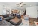 Cozy living room with plush seating, open to the kitchen with a breakfast bar, and hardwood floors at 1578 Whitman Ct, York, SC 29745