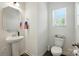 Charming powder room with pedestal sink, bright window, and modern fixtures; perfect for guests at 1578 Whitman Ct, York, SC 29745