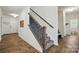 Modern staircase with gray carpeted steps and black wrought iron spindles, adding elegance to the home's entryway at 1578 Whitman Ct, York, SC 29745