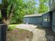 Backyard showcasing a house and a grassy yard with mature trees and a concrete patio at 1620 Matthews Dr, Rock Hill, SC 29732