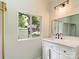 Bathroom features a white vanity, black fixtures, and a window with neighborhood views at 1620 Matthews Dr, Rock Hill, SC 29732