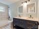 Updated bathroom with double vanity, modern fixtures, and tiled shower-tub combination at 1620 Matthews Dr, Rock Hill, SC 29732