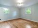 Bedroom with hardwood floors, neutral paint, and large windows providing natural light at 1620 Matthews Dr, Rock Hill, SC 29732