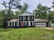 Inviting home boasts traditional charm, a two-car garage and a front yard lush with mature trees at 1620 Matthews Dr, Rock Hill, SC 29732