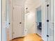 Hallway view featuring hardwood floors, white doors, and a modern light fixture at 1620 Matthews Dr, Rock Hill, SC 29732
