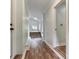 Hallway view with hardwood floors leading to a room with stairs and window at 1620 Matthews Dr, Rock Hill, SC 29732