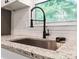 Close up of kitchen sink features granite counters, subway tile and stainless faucet at 1620 Matthews Dr, Rock Hill, SC 29732