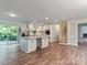 Open concept kitchen with stainless steel appliances, island with granite countertop, and access to deck at 1620 Matthews Dr, Rock Hill, SC 29732