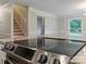 Modern kitchen features stainless cooktop, granite countertops and hardwood floors at 1620 Matthews Dr, Rock Hill, SC 29732