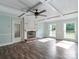 Inviting living room features a decorative fireplace, ceiling fan, and classic wainscoting at 1620 Matthews Dr, Rock Hill, SC 29732