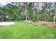 Spacious backyard with mature trees and landscaping creates a private outdoor retreat at 17408 Summer Place Dr, Cornelius, NC 28031